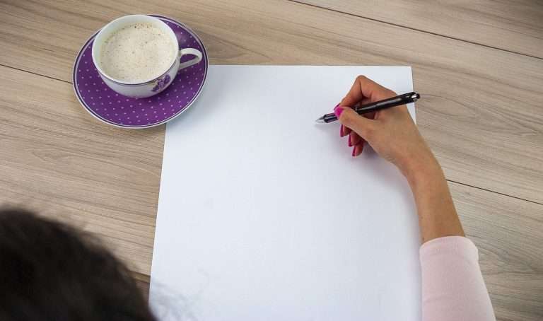 A woman, writing on a blank sheet of paper, looks like she needs templates for writing essays